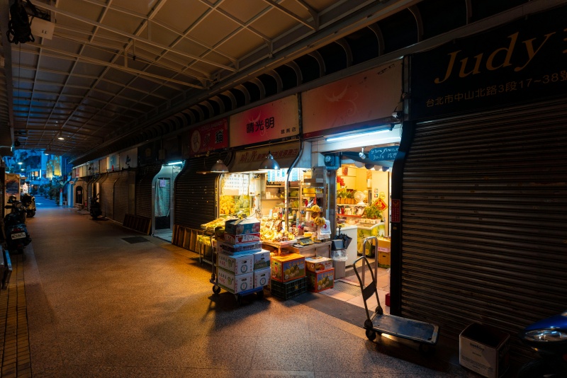 Retail Lighting Comparison for Color Rendering Retail buyer examining fabric and packaging colors under different LED lighting samples during product selection
