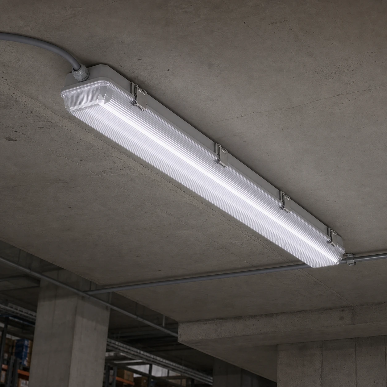Replaceable-tube LED tri-proof fixture mounted to a concrete ceiling with side clips and cable entry visible
