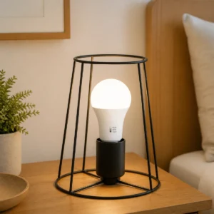 A60 3-CCT selectable LED bulb installed upright in an indoor table-lamp socket with the selector visible