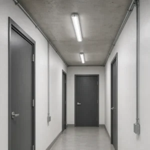 Two 1200 mm replaceable-tube tri-proof fixtures surface mounted in a commercial service corridor