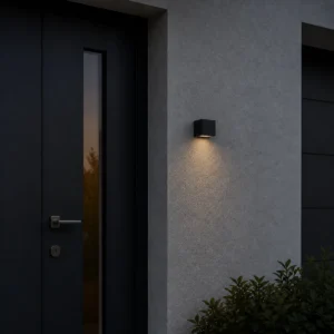 XGYSWL-STRP-E0.15 low-output solar wall light installed beside an exterior entrance at dusk