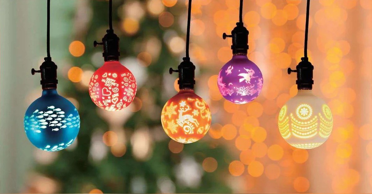 Several colored patterned decorative LED bulbs displayed in pendant holders