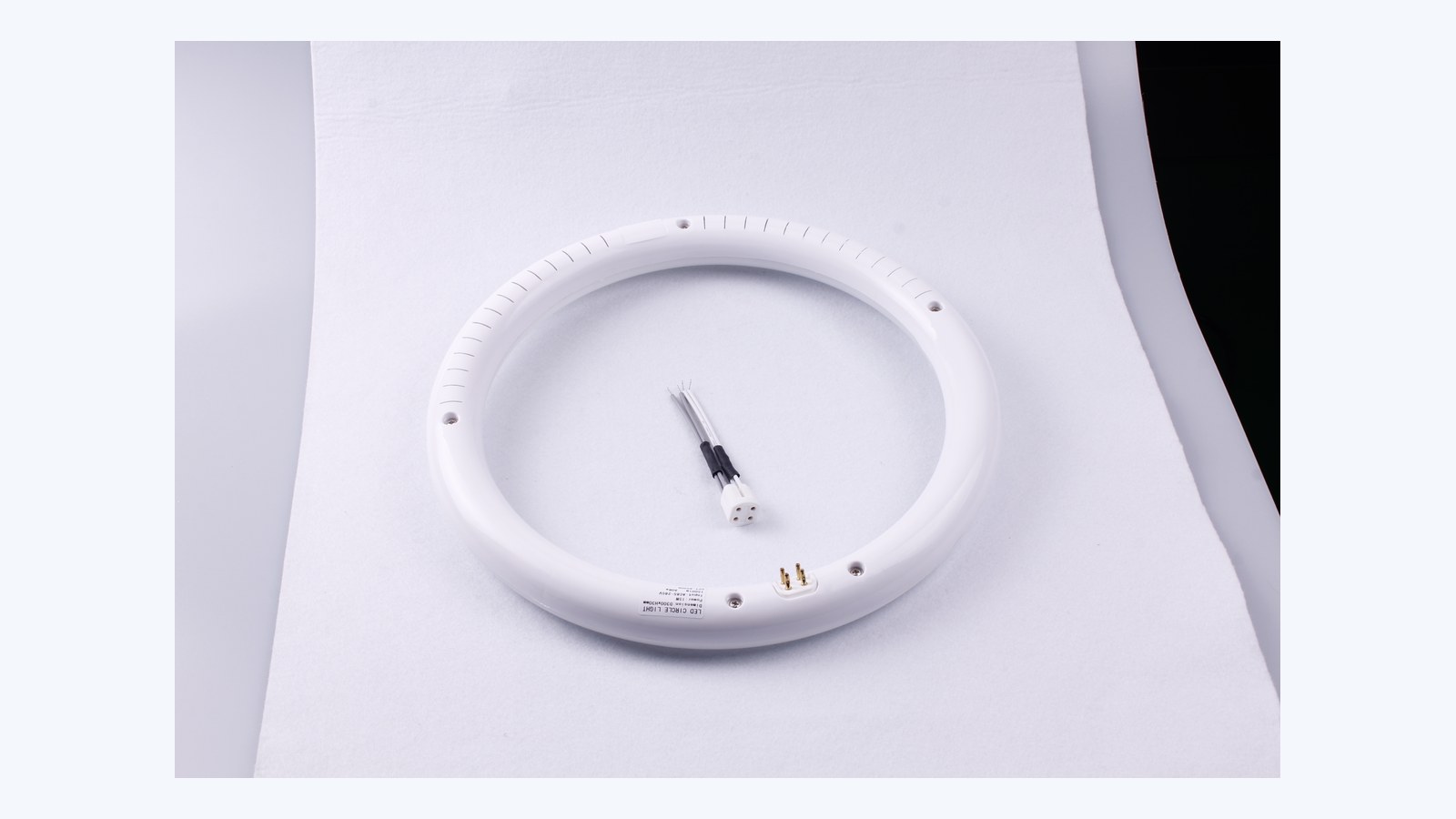 New Lights LED circular lamp with a four-hole connector lead and matching pins