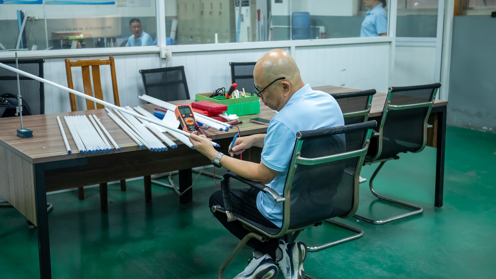 New Lights technician using a multimeter while checking LED tube samples