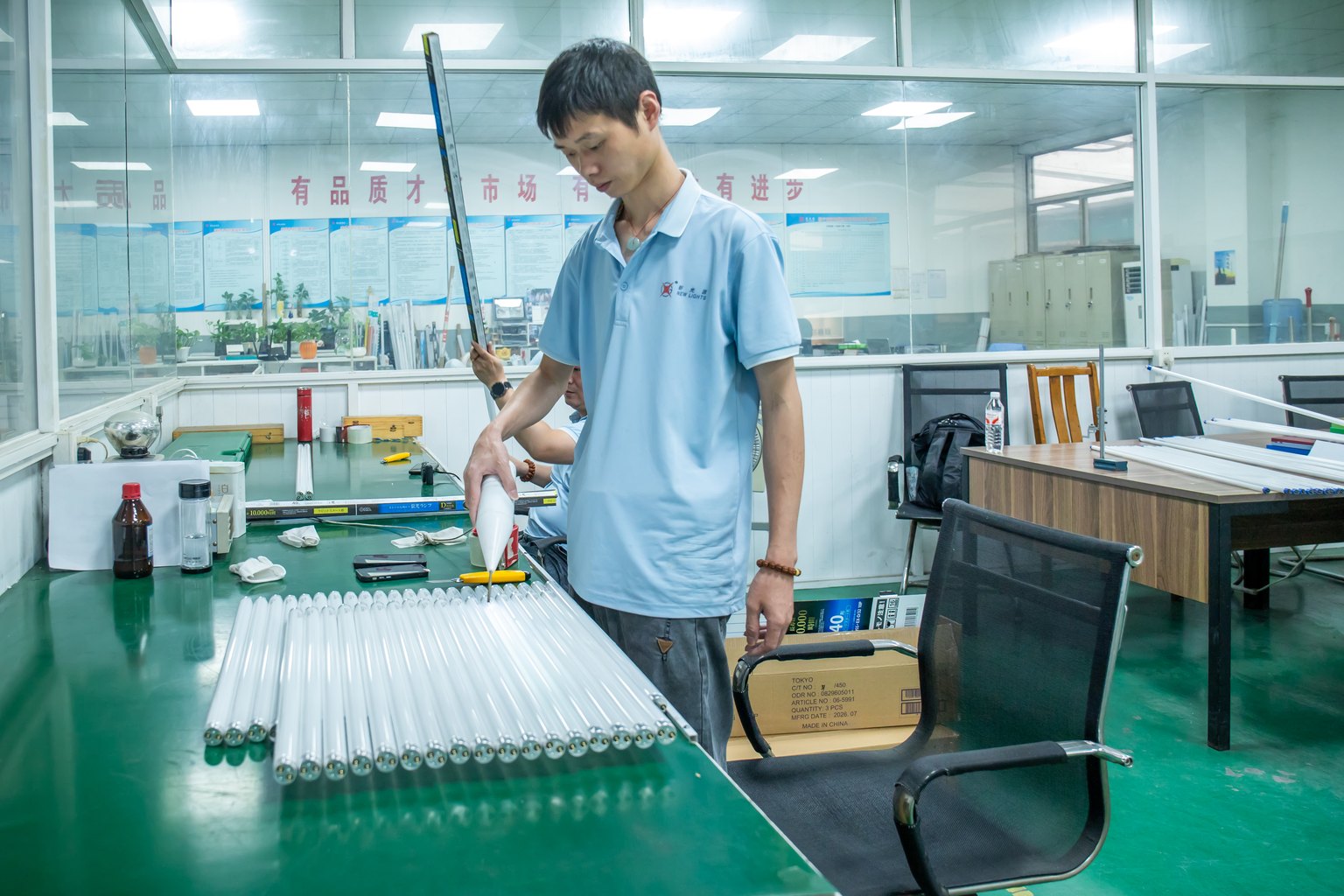 New Lights staff member visually inspecting assembled LED tubes