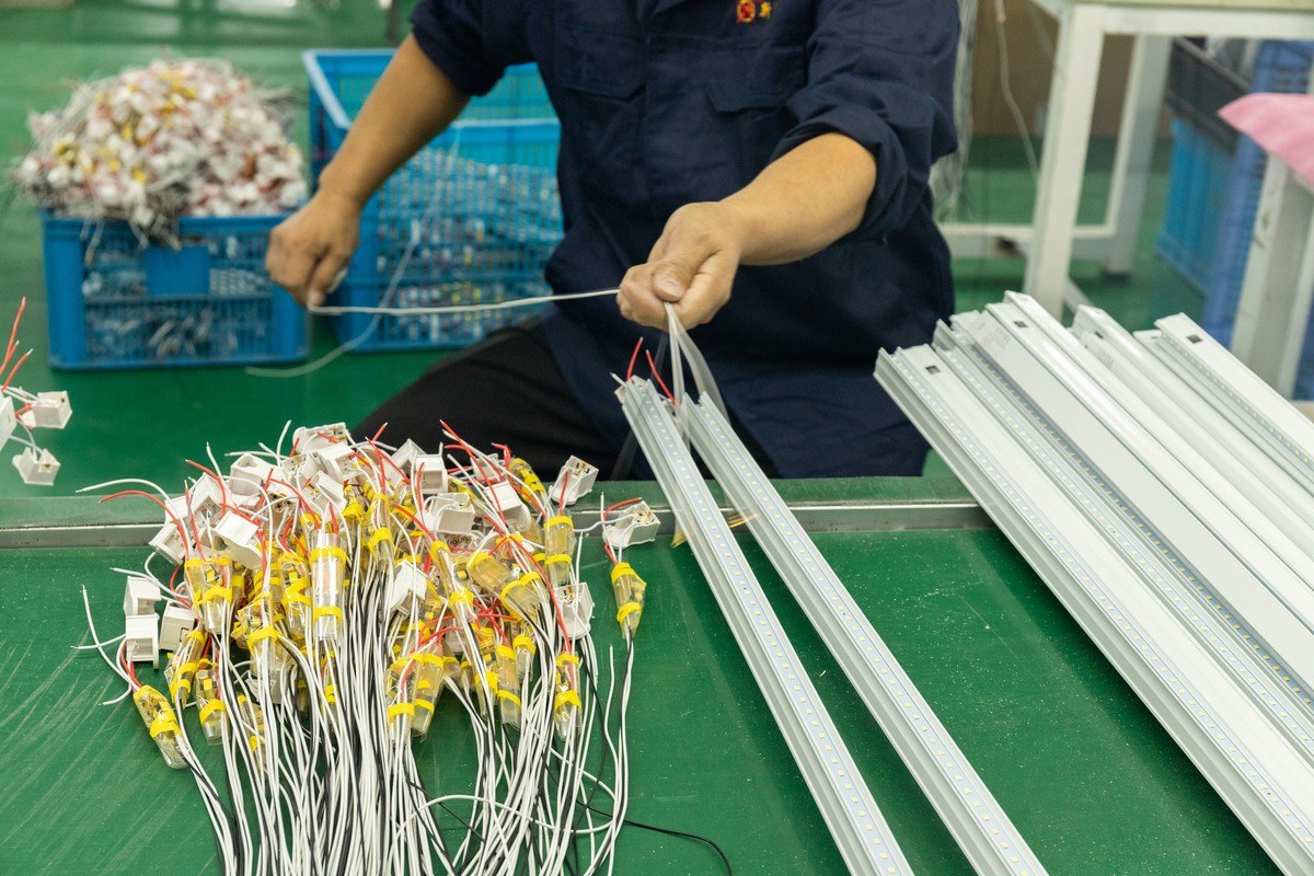 New Lights worker assembling drivers and linear LED boards