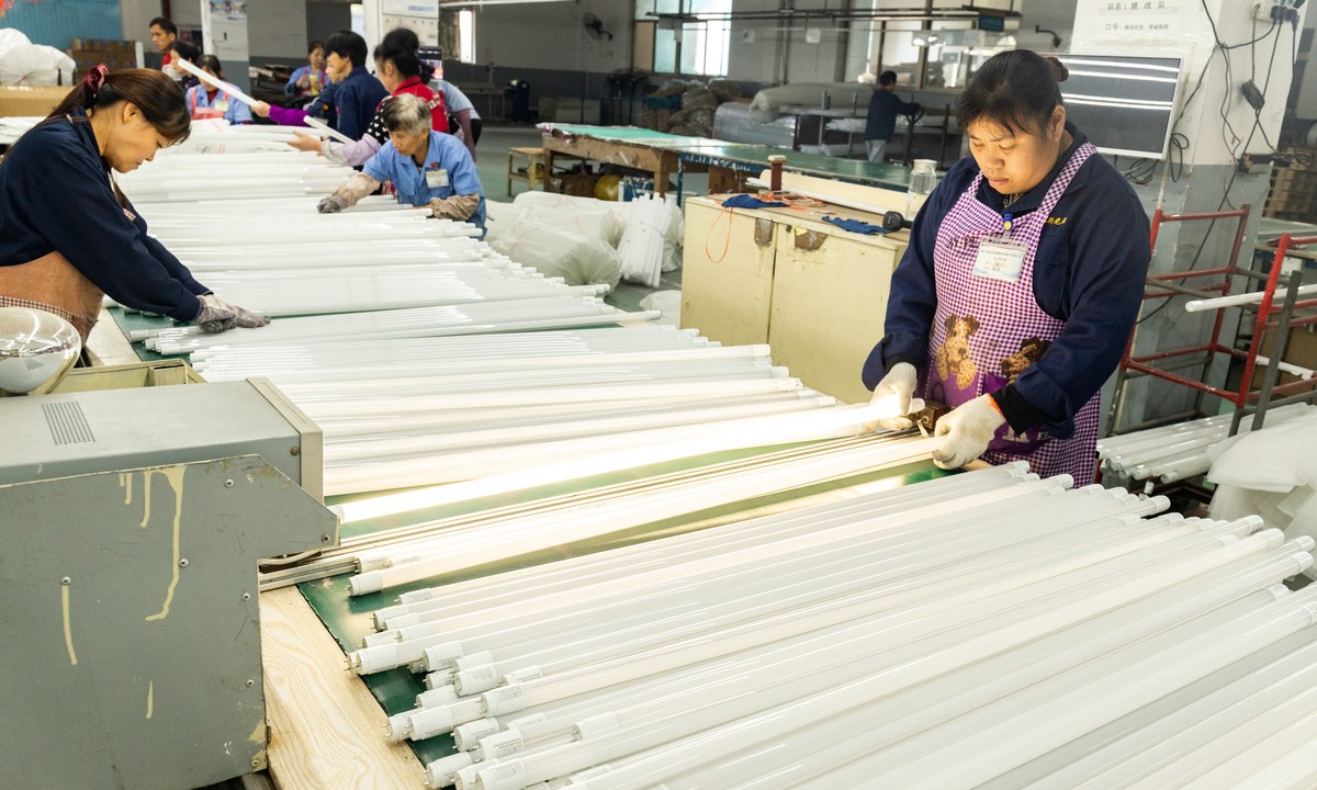 New Lights production team inspecting LED tubes before packaging