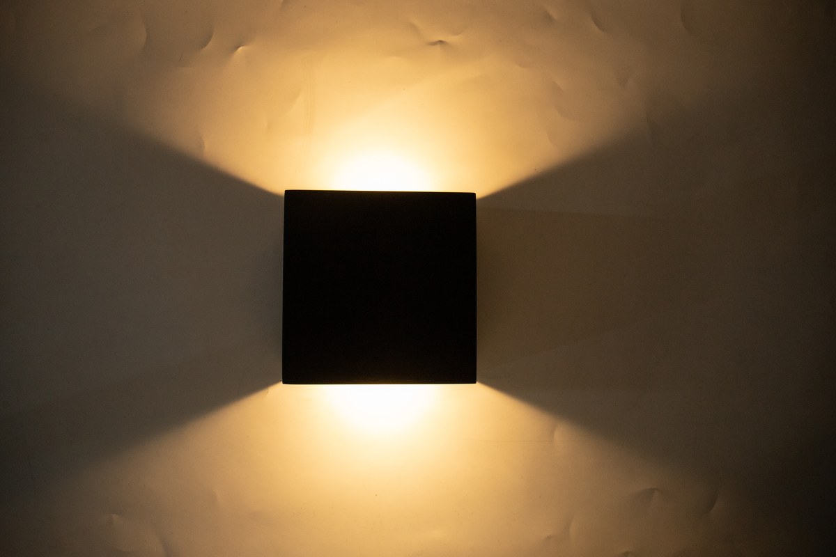 New Lights wall light showing controlled upward and downward beams on a textured surface