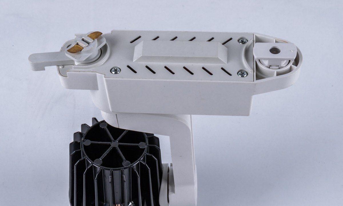 Rear view of a New Lights track spotlight showing the track adapter and finned thermal body