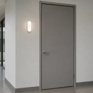 Compact oval IP44/IP54 LED bulkhead light mounted beside an interior corridor door